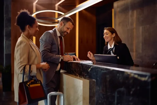 happy-business-couple-checking-in-at-the-hotel-2026-01-09-12-07-10-utc-696a05f7170ed