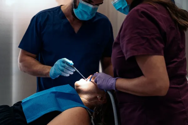 woman-patient-with-two-dentist-2024-10-14-04-07-38-utc-68230162cd502