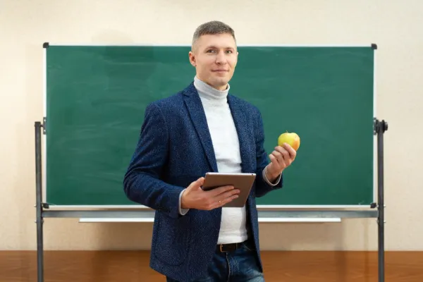 portrait-of-a-smiling-teacher-with-a-tablet-comput-2025-01-10-20-35-49-utc-694fd1b4883b2
