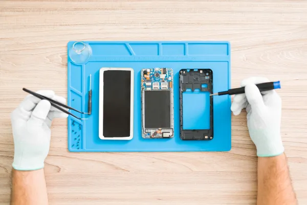 young-man-fixing-a-smartphone-with-tweezers-2026-03-16-06-44-14-utc-69e0d18fa259b